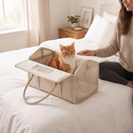 Cat sitting in the RoamNest carrier with its top unzipped and folded open